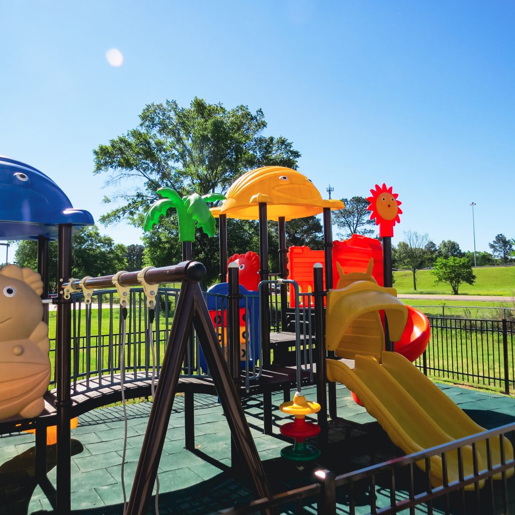A colorful playground outside the office under a blue sky