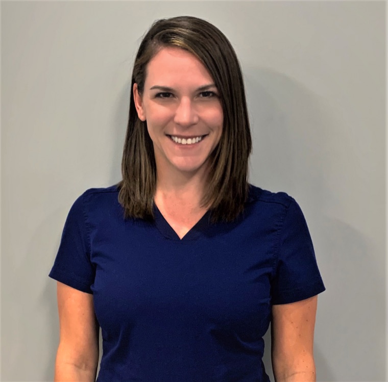 Dr. Jennifer Mooney in navy scrubs, smiling